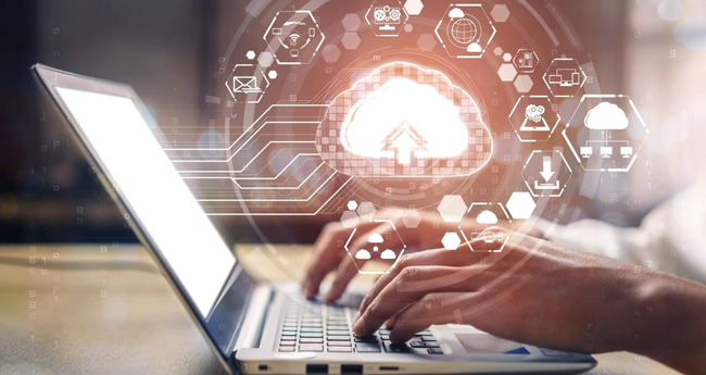 Hands typing on a laptop with cloud computing graphics