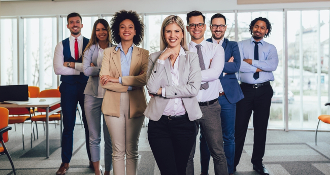 Group of professionals standing together, looking confidently into the camera, reflecting Eccera’s collaborative and people-driven approach