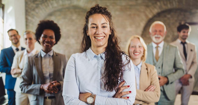 Confident woman leading a diverse group of professionals