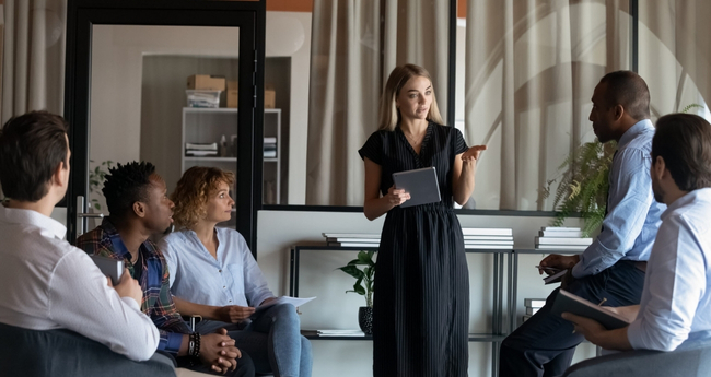 Woman leading a discussion in a modern tech office