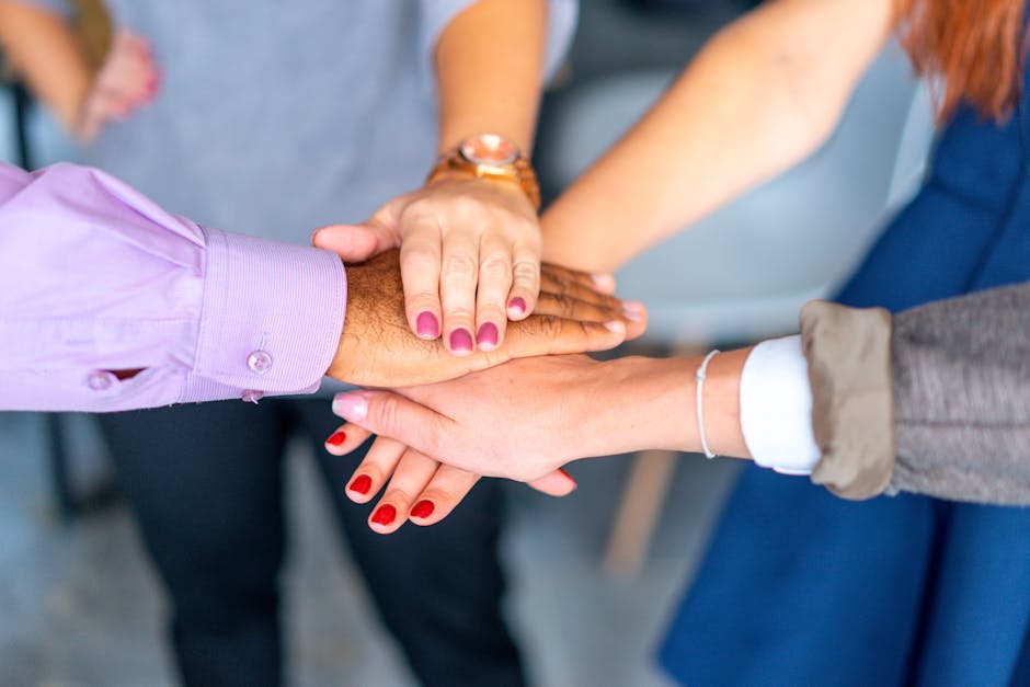 Close-up of diverse hands joined together in a symbol of unity and teamwork